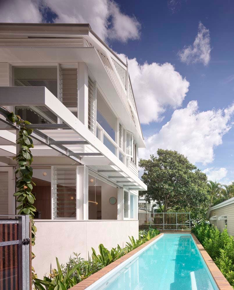 Rear facade featuring lap pool at Perimeter House, built by Brisbane custom home builders Bluebird Design & Build